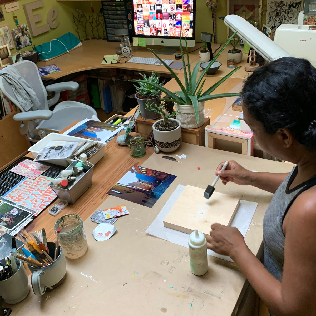 Nadya Edwards, mixed-media artist in her home studio creating art.
